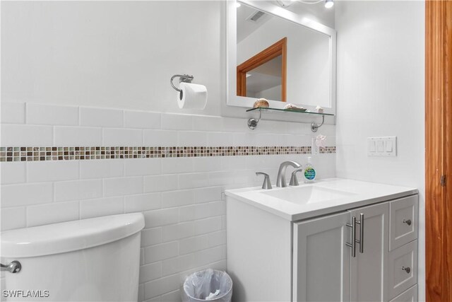 150 Pearl St, Fort Myers Beach, FL 33931 - bathroom with tile walls, vanity, and toilet