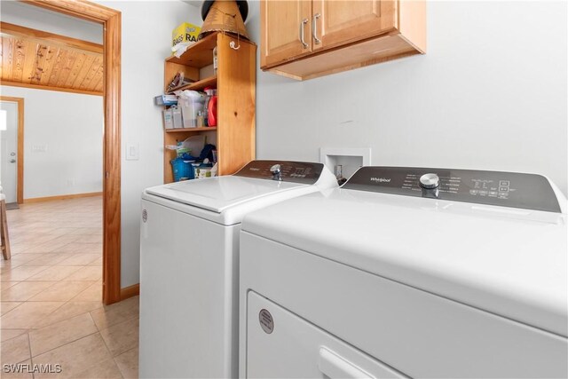 150 Pearl St, Fort Myers Beach, FL 33931 - laundry area featuring independent washer and dryer, cabinet space, light tile patterned floors, and baseboards