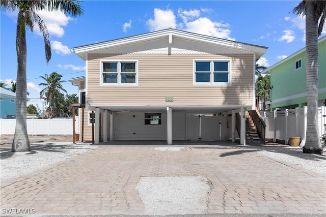 150 Pearl St, Fort Myers Beach, FL 33931 - coastal inspired home featuring a carport, stairway, and decorative driveway