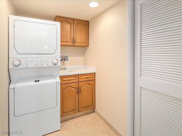 840 S Collier Blvd Unit 706, Marco Island, FL 34145 - washroom featuring stacked washer / drying machine, cabinet space, light tile patterned floors, baseboards, and recessed lighting