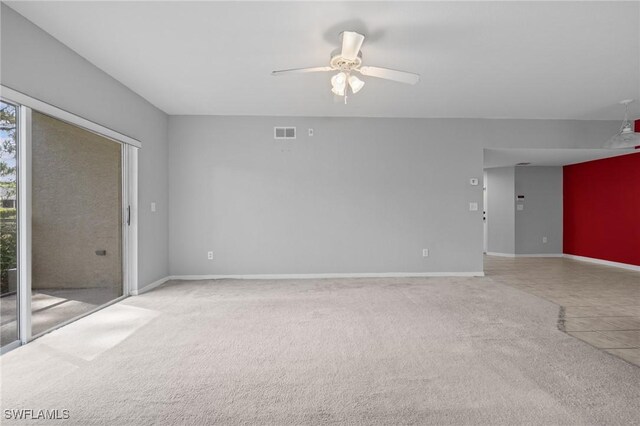 27075 Matheson Ave Unit 105, Bonita Springs, FL 34135 - unfurnished living room featuring a ceiling fan, carpet floors, baseboards, and tile patterned floors
