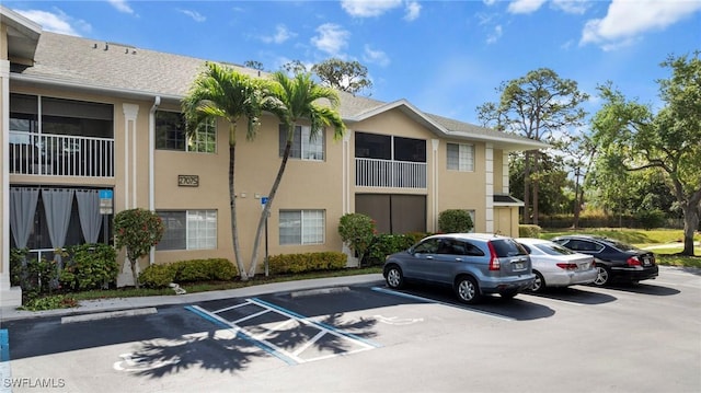 27075 Matheson Ave Unit 105, Bonita Springs, FL 34135 - view of building exterior with uncovered parking
