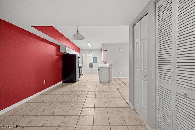 27075 Matheson Ave Unit 105, Bonita Springs, FL 34135 - kitchen featuring freestanding refrigerator, baseboards, light countertops, and light tile patterned flooring