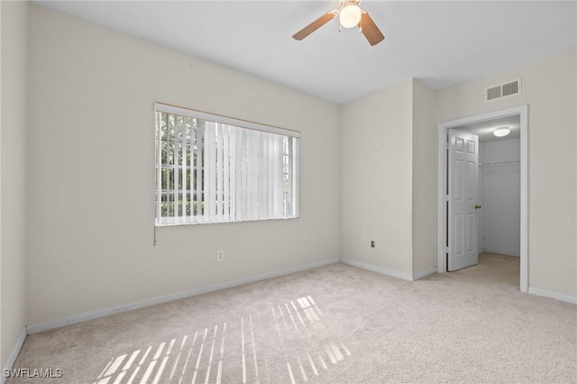 27075 Matheson Ave Unit 105, Bonita Springs, FL 34135 - unfurnished bedroom featuring carpet floors, baseboards, a closet, a walk in closet, and ceiling fan