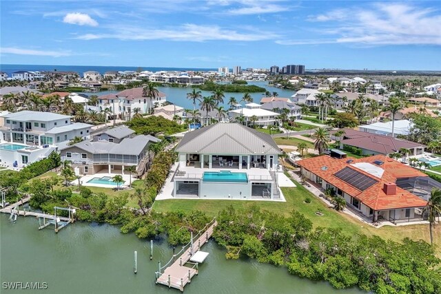 26906 Mclaughlin Blvd, Bonita Springs, FL 34134 - aerial perspective of suburban area with a nearby body of water and a pool area
