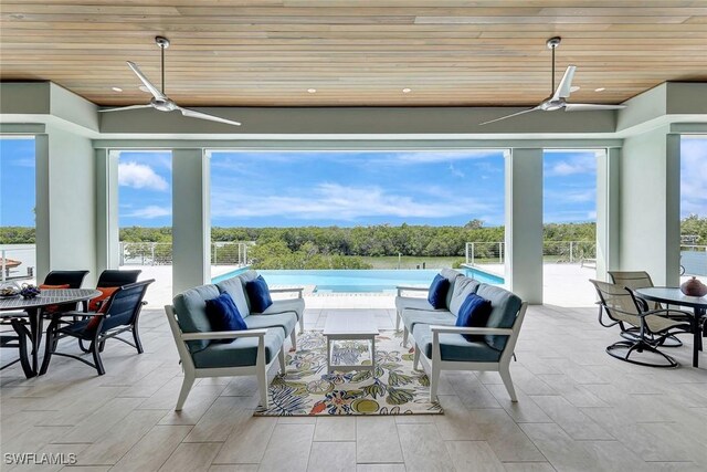 26906 Mclaughlin Blvd, Bonita Springs, FL 34134 - view of patio / terrace with ceiling fan, an outdoor hangout area, and outdoor dining area
