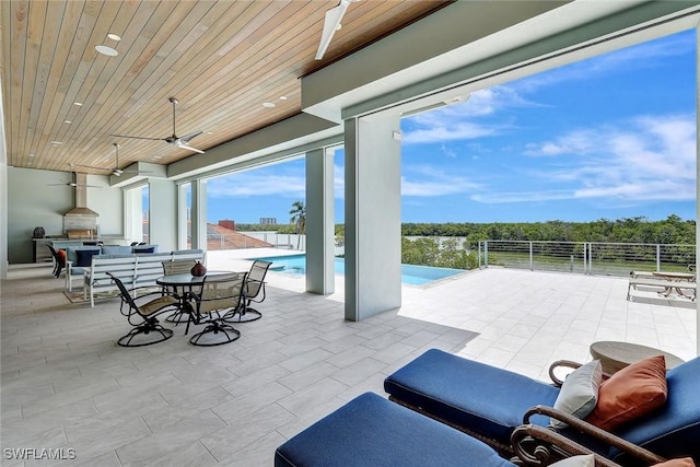 26906 Mclaughlin Blvd, Bonita Springs, FL 34134 - view of patio / terrace with a ceiling fan, an outdoor kitchen, fence, and outdoor dining area