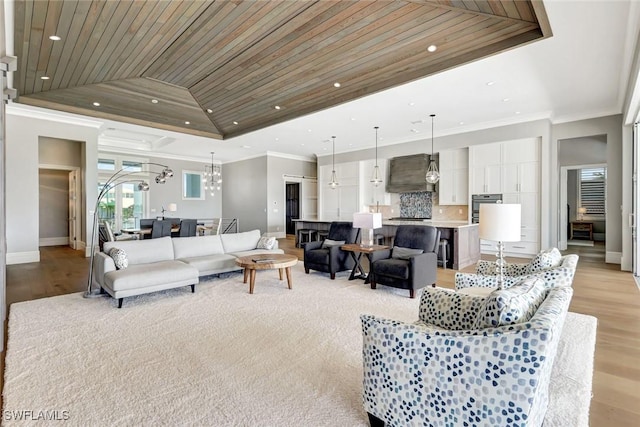 26906 Mclaughlin Blvd, Bonita Springs, FL 34134 - living room featuring ornamental molding, baseboards, light wood-style flooring, a raised ceiling, and recessed lighting