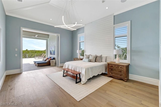 26906 Mclaughlin Blvd, Bonita Springs, FL 34134 - bedroom with baseboards, light wood-style flooring, a chandelier, and crown molding