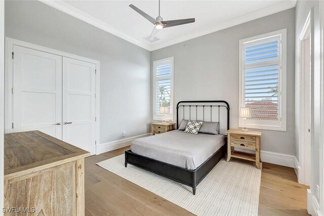 26906 Mclaughlin Blvd, Bonita Springs, FL 34134 - bedroom featuring wood finished floors, baseboards, ornamental molding, a ceiling fan, and a closet