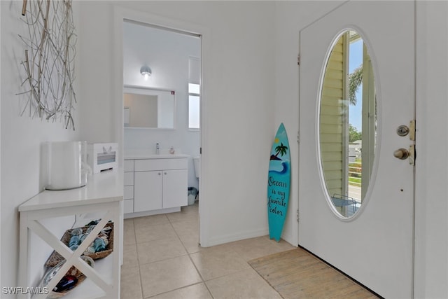4471 Mariner Rd, Bonita Springs, FL 34134 - entrance foyer with plenty of natural light, light tile patterned floors, and baseboards
