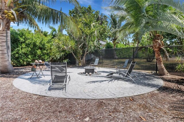 4471 Mariner Rd, Bonita Springs, FL 34134 - view of patio featuring an outdoor fire pit and fence