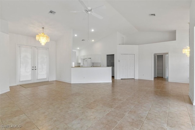 unfurnished living room with a chandelier, high vaulted ceiling, french doors, ceiling fan, and light tile patterned floors