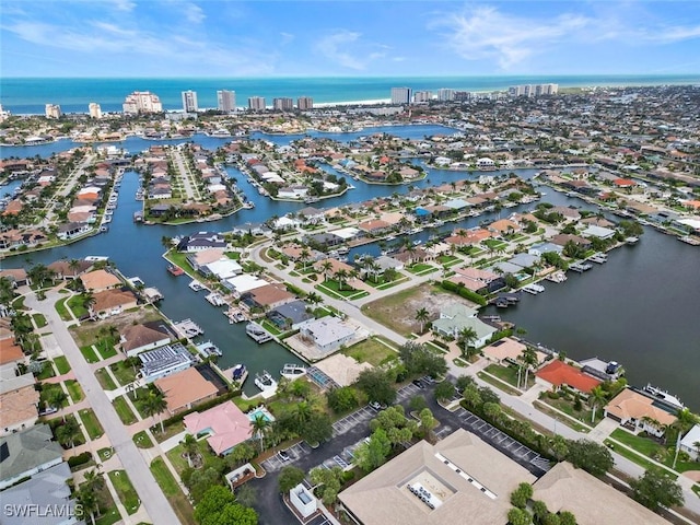 aerial overview of property's location with a nearby body of water and nearby suburban area