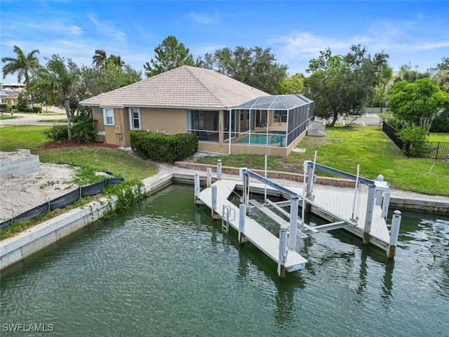 dock featuring boat lift, a water view, an outdoor pool, a lanai, and a yard