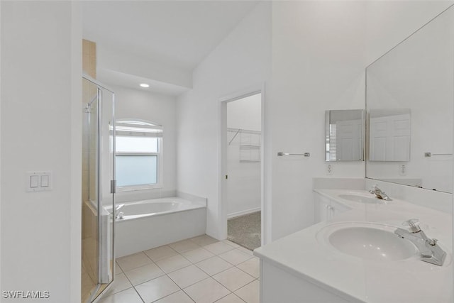 full bathroom featuring a shower stall, tile patterned flooring, a garden tub, a walk in closet, and double vanity
