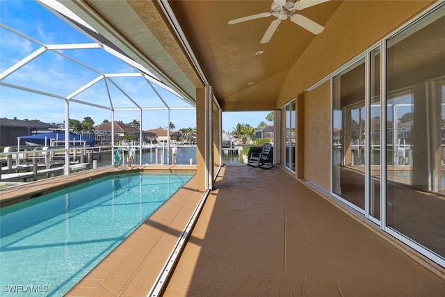 view of swimming pool featuring boat lift, a dock, a water view, and a ceiling fan