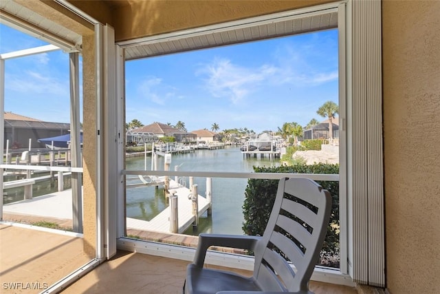 balcony featuring a water view and a residential view