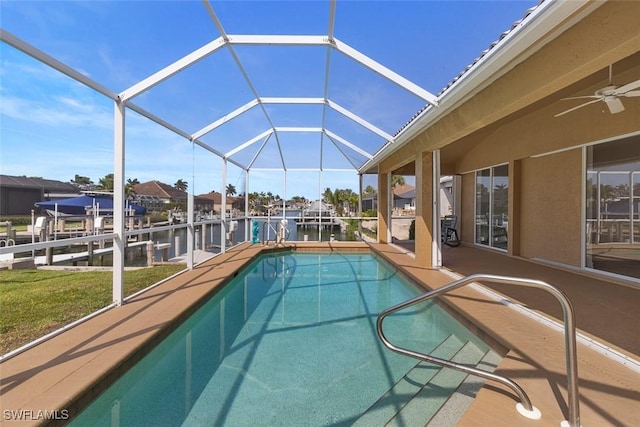swimming pool featuring boat lift, a boat dock, a patio, and a lanai