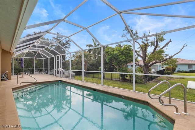 outdoor pool with a patio, a yard, and a lanai