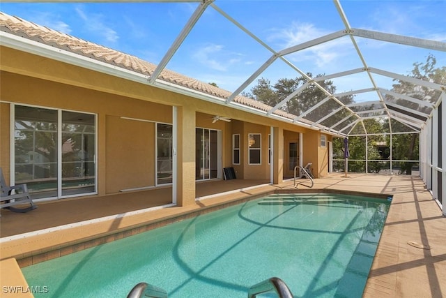 swimming pool featuring a patio, ceiling fan, and glass enclosure