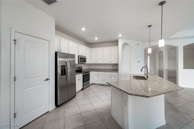 3434 Nombella Ct, Fort Myers, FL 33905 - kitchen featuring appliances with stainless steel finishes, a sink, arched walkways, light tile patterned floors, and recessed lighting