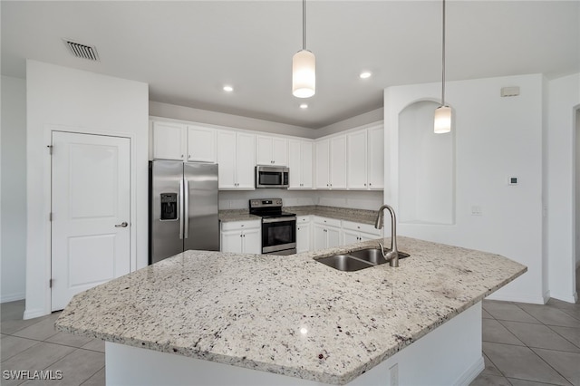 3434 Nombella Ct, Fort Myers, FL 33905 - kitchen featuring appliances with stainless steel finishes, a sink, light tile patterned flooring, white cabinetry, and recessed lighting