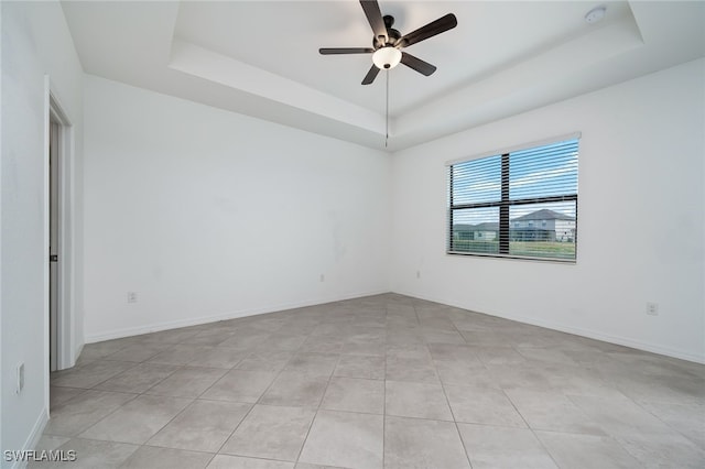 3434 Nombella Ct, Fort Myers, FL 33905 - empty room featuring a raised ceiling, a ceiling fan, light tile patterned floors, a smoke detector, and baseboards