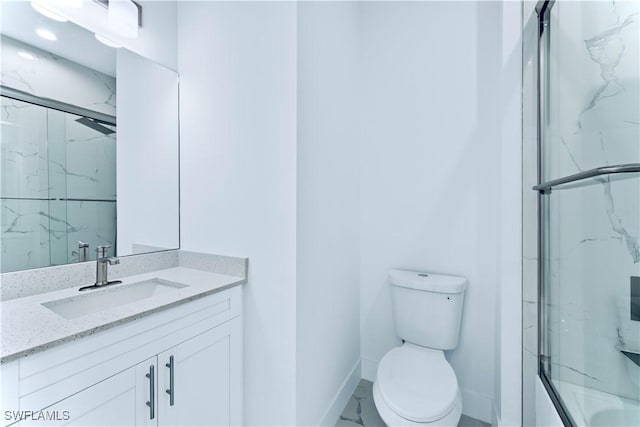 full bathroom with a marble finish shower, baseboards, toilet, vanity, and marble finish floors
