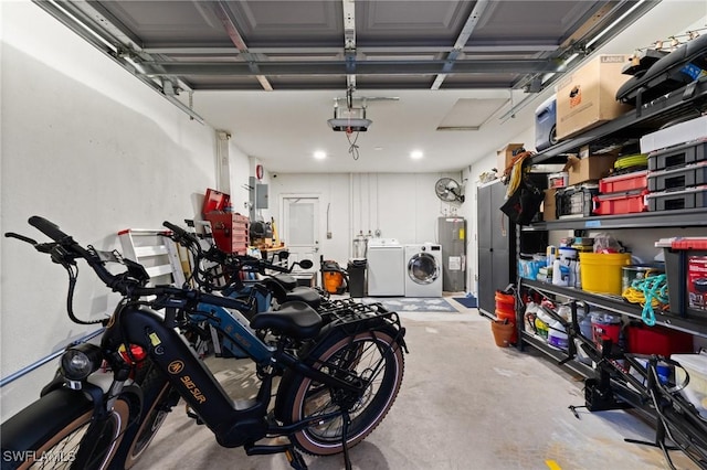 garage featuring washing machine and dryer, electric water heater, a garage door opener, and recessed lighting