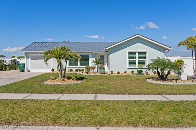 ranch-style house featuring an attached garage, stucco siding, a standing seam roof, concrete driveway, and a front yard