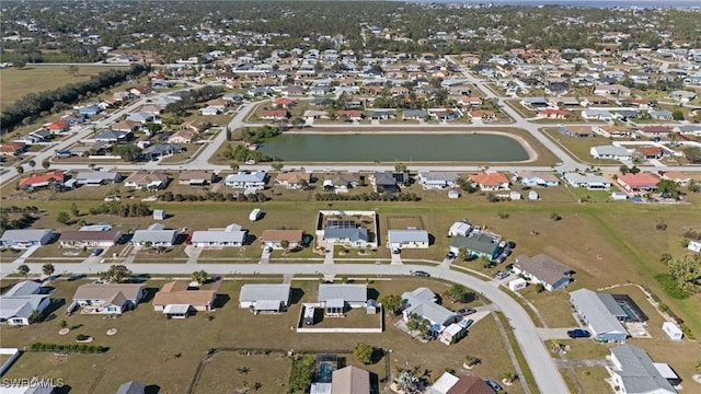 aerial view of property's location featuring a nearby body of water and nearby suburban area