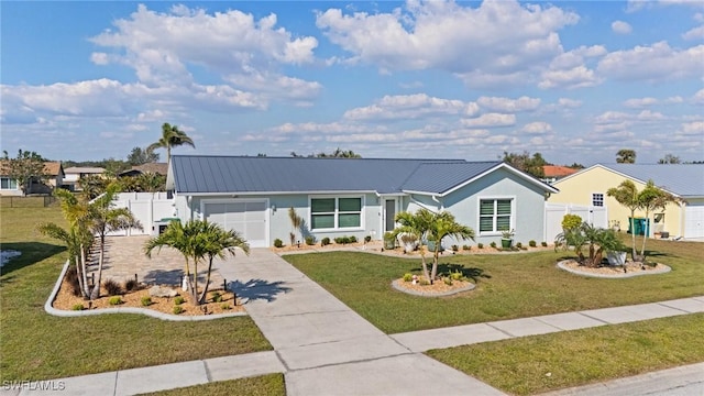 view of front of home featuring concrete driveway, an attached garage, metal roof, stucco siding, and a standing seam roof