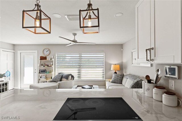 living area with a ceiling fan