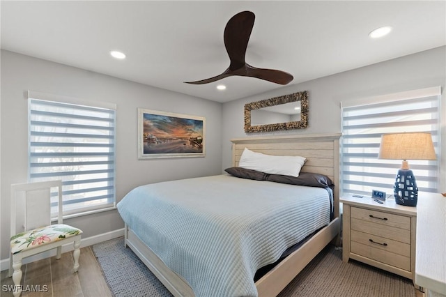 bedroom featuring wood finished floors, baseboards, recessed lighting, and a ceiling fan