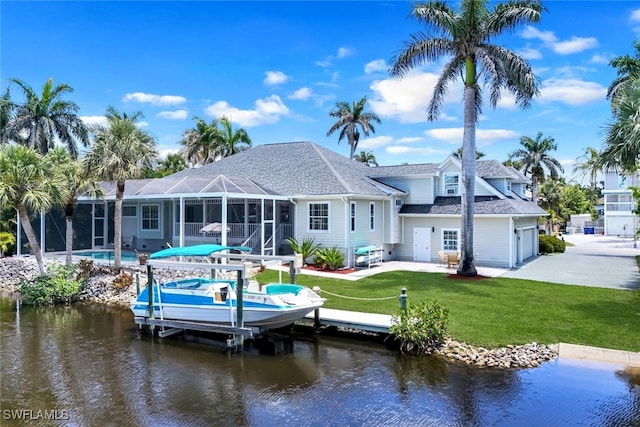 27150 Mora Rd, Bonita Springs, FL 34135 - back of property featuring a water view, boat lift, a lawn, and a patio area