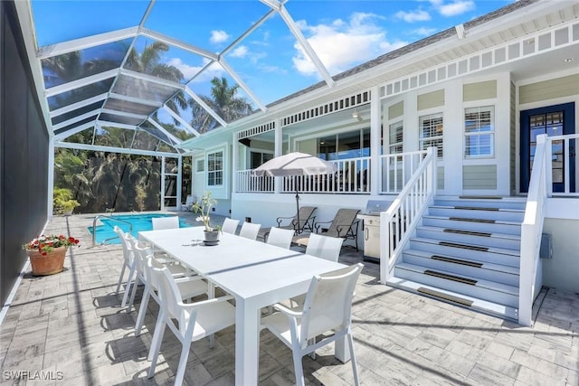 27150 Mora Rd, Bonita Springs, FL 34135 - view of patio with an outdoor pool, glass enclosure, a grill, and outdoor dining area