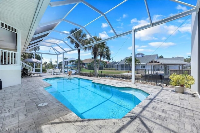 27150 Mora Rd, Bonita Springs, FL 34135 - outdoor pool featuring a patio, a residential view, and glass enclosure