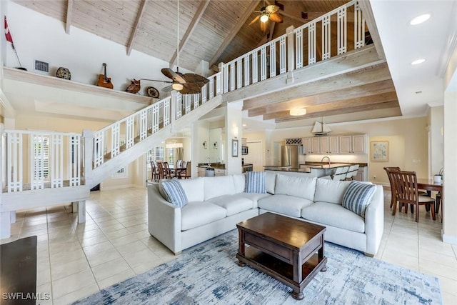 27150 Mora Rd, Bonita Springs, FL 34135 - living room with ceiling fan, light tile patterned flooring, stairway, wooden ceiling with exposed beams, and baseboards