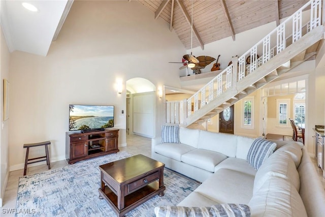 27150 Mora Rd, Bonita Springs, FL 34135 - tiled living room featuring arched walkways, high vaulted ceiling, stairway, a ceiling fan, and baseboards