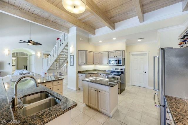 27150 Mora Rd, Bonita Springs, FL 34135 - kitchen featuring appliances with stainless steel finishes, a sink, a kitchen island, wooden ceiling with exposed beams, and dark stone counters