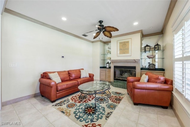 27150 Mora Rd, Bonita Springs, FL 34135 - living room with crown molding, a ceiling fan, a glass covered fireplace, light tile patterned floors, and recessed lighting