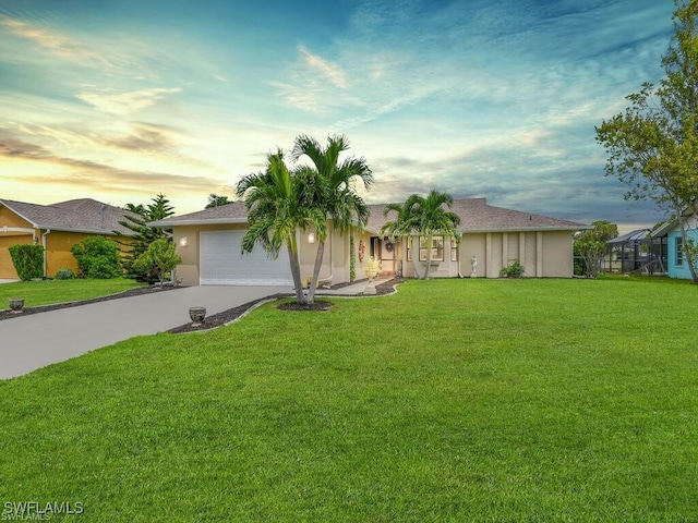 view of front of property featuring concrete driveway, a front lawn, a garage, and stucco siding