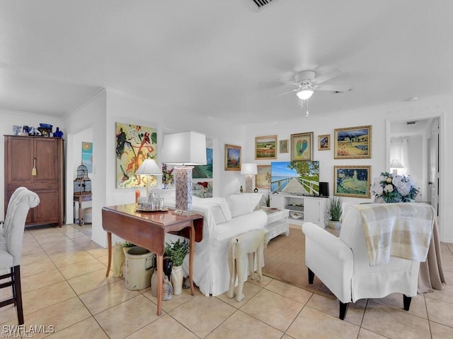 living area with light tile patterned floors, ceiling fan, and ornamental molding