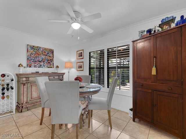 dining area with ornamental molding, light tile patterned flooring, and ceiling fan