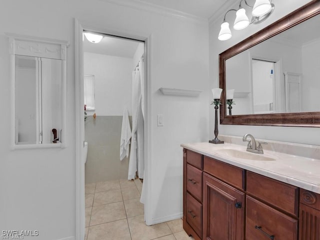 bathroom featuring tile patterned flooring, vanity, ornamental molding, and baseboards