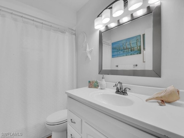 bathroom featuring vanity, toilet, and a shower with shower curtain