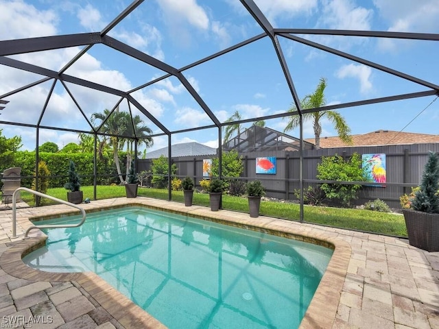outdoor pool featuring a patio and glass enclosure