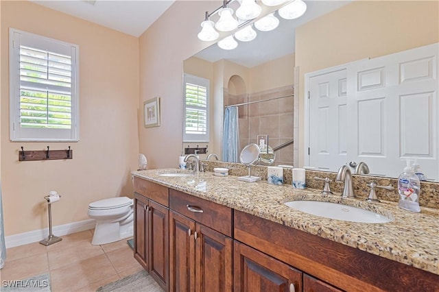 7810 Twin Eagle Ln, Fort Myers, FL 33912 - full bathroom featuring toilet, a tile shower, baseboards, double vanity, and tile patterned floors