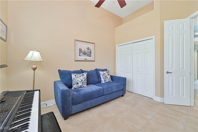 7810 Twin Eagle Ln, Fort Myers, FL 33912 - living area with a ceiling fan, light tile patterned flooring, baseboards, and a towering ceiling